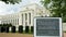 A debt clock and the exterior of the federal reserve building