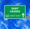 DEBT CRISES road sign against clear blue sky