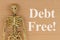 Debt Free word message with skeleton on brown textured cardboard