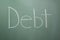 Debt written on chalkboard