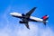 Dec 27, 2019 San Jose / CA / USA - Delta Airlines aircraft in flight; the Delta Logo visible on the airplane underbelly; blue sky