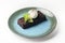 Decadent brownie with ice cream served on a blue plate isolated on white. Chocolate dessert with vanilla ice-cream.