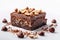 Decadent brownie slice adorned with hazelnuts, on pristine white canvas