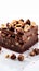 Decadent brownie slice adorned with hazelnuts, on pristine white canvas