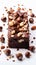Decadent brownie slice adorned with hazelnuts, on pristine white canvas