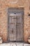 Decayed wooden door with old carvings