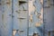 Decaying planks of wood with blue peeling paint