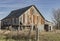 Decaying and rusting barn in a rural area.