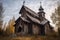 decaying wooden church with a crooked cross on top