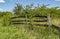 A decaying wooden fence in a rural area.