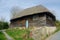 Decaying Wooden thatched storage building