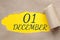 december 01. 01th day of the month, calendar date.Hole in paper with edges torn off. Yellow background is visible
