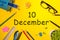 December 10th. Day 10 of december month. Calendar on yellow businessman workplace background. Winter time