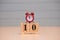 December 10th set on wooden calendar and red alarm clock with blue background