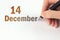 December 14th. Day 14 of month, Calendar date. The hand holds a black pen and writes the calendar date. Winter month, day of the