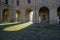 December 2020 Parma, Italy: Courtyard of the the Palazzo della Pilotta with Heads exhibition in sunlight and shadow
