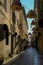 December 2020 Parma, Italy: narrow street in the old town with colorful lamps and chandeliers decorations hanging over the street.