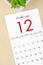 December 2022 calendar with plant pot on brown paper background