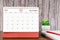 The December 2022 Monthly desk calendar for 2022 year with open diary wooden background