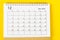 The December 2022 Monthly desk calendar for 2022 year on yellow background