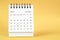 The December 2022 Monthly desk calendar for 2022 year on yellow background