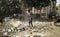 December, 2022, Raipur, India: Man sweeping the trash with broom and polyhthene big garbage area, Man cleaning the polluted area,
