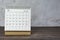 December 2022 white calendar on wooden desk. Copy space.