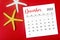 The December 2023 Monthly calendar with Starfish on red background