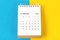 The December 2023 Monthly desk calendar for 2023 year on blue and yellow background