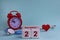 December 22th. White wooden blocks of the calendar with the date, clock and stethoscope on a blue pastel background. Selective