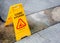 December 25, 2019 : Yellow signage of cleaning in progress on wet floor tile for indoor