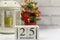 December 25 on a white wooden calendar on a light background next to the Christmas tree.The Concept Of Christmas