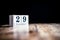 December 29th, 29 December, Twenty Nineth of December - White block calendar on vintage table - Date on dark background