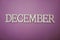 December alphabet letter with space copy on purple background