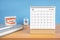 The December monthly desk calendar for 2023 year and model dentures on the table. Dental health concepts