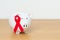 December World Aids Day, acquired immune deficiency syndrome, Red Ribbon with Piggy Bank for support illness life. Health,