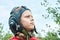 Decisive boy in vintage pilot helmet looks into sky in park