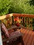 Deck and adirondack chair overlooking wooded area