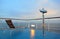 Deck-chair and binocular on ship overlooking city