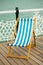 Deck chair on Brighton pier promenade.