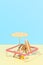 Deck chair with umbrella, surfboard and ball on the beach. An isolated vacation spot at a resort.