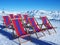 Deck chairs in front of ski slopes in alps mountains