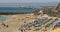 Deck chairs, umbrellas and bathers in Playa Dorada, Lanzarote, Canary Islands,