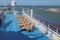Deck of cruise liner, sun beds in lounge zone