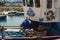 A deck hand works on a local fishing trawler berthed in the crowded harbor in Los Cristianos in Spanish Island of Teneriffe