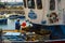 A deck hand works on a local fishing trawler berthed in the crowded harbor in Los Cristianos in Spanish Island of Teneriffe