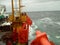 The deck lay barge. Pipes and Lifting cranes on the ship. Equipment for laying a pipeline on the seabed