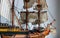 Deck of a toy wooden sailboat with fabric sails and thread ropes detailed stock photo