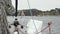 Deck of a white yacht with a blue rope in ocean.