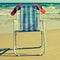 deckchair and orange flip-flops on the beach, with a retro effect